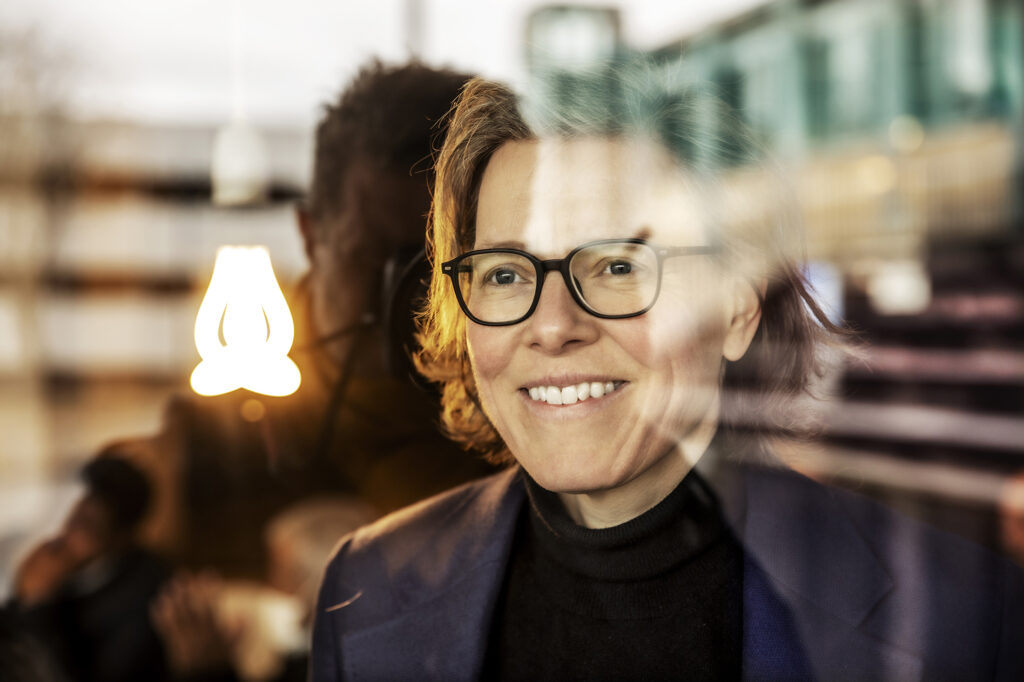 Photo of Lena Andersson in front of a window.